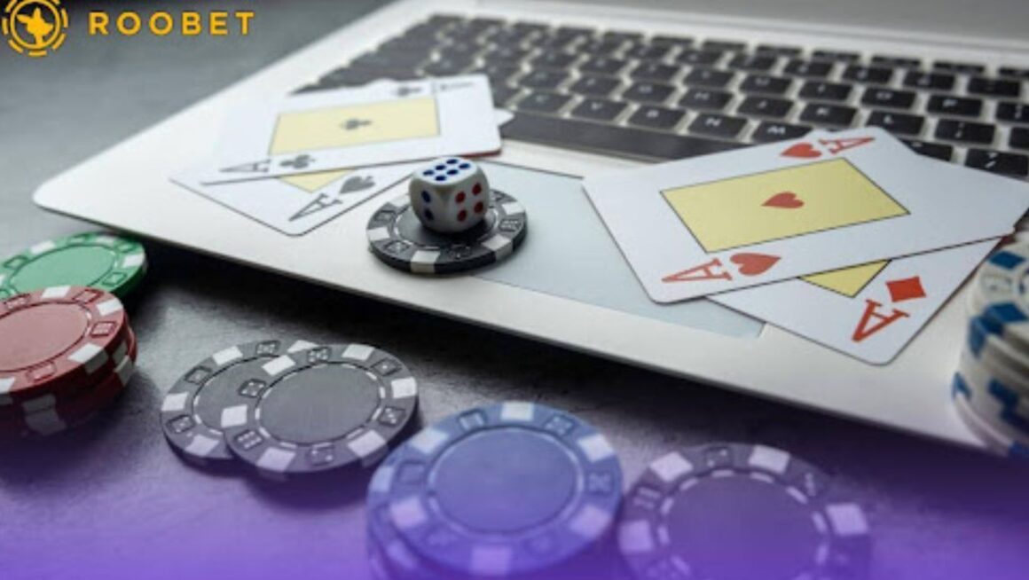 An image of playing chips, dice, and cards on a laptop