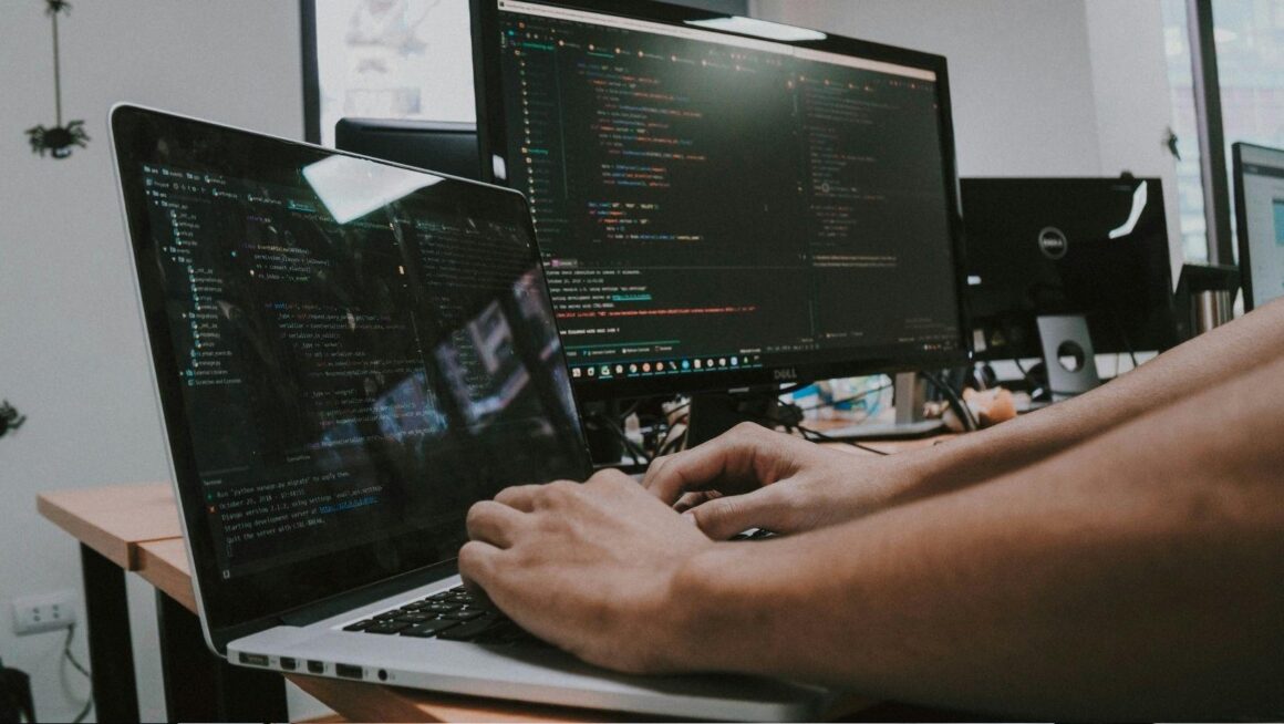 A professional working at a laptop, weighing a technology decision for their business.